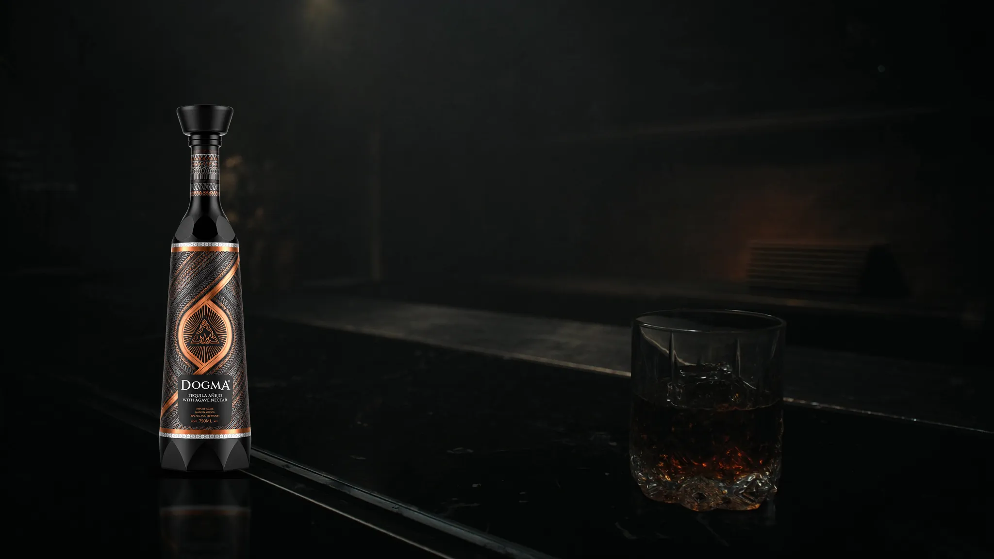 DOGMA Signature beside an amber cocktail on a dark bar